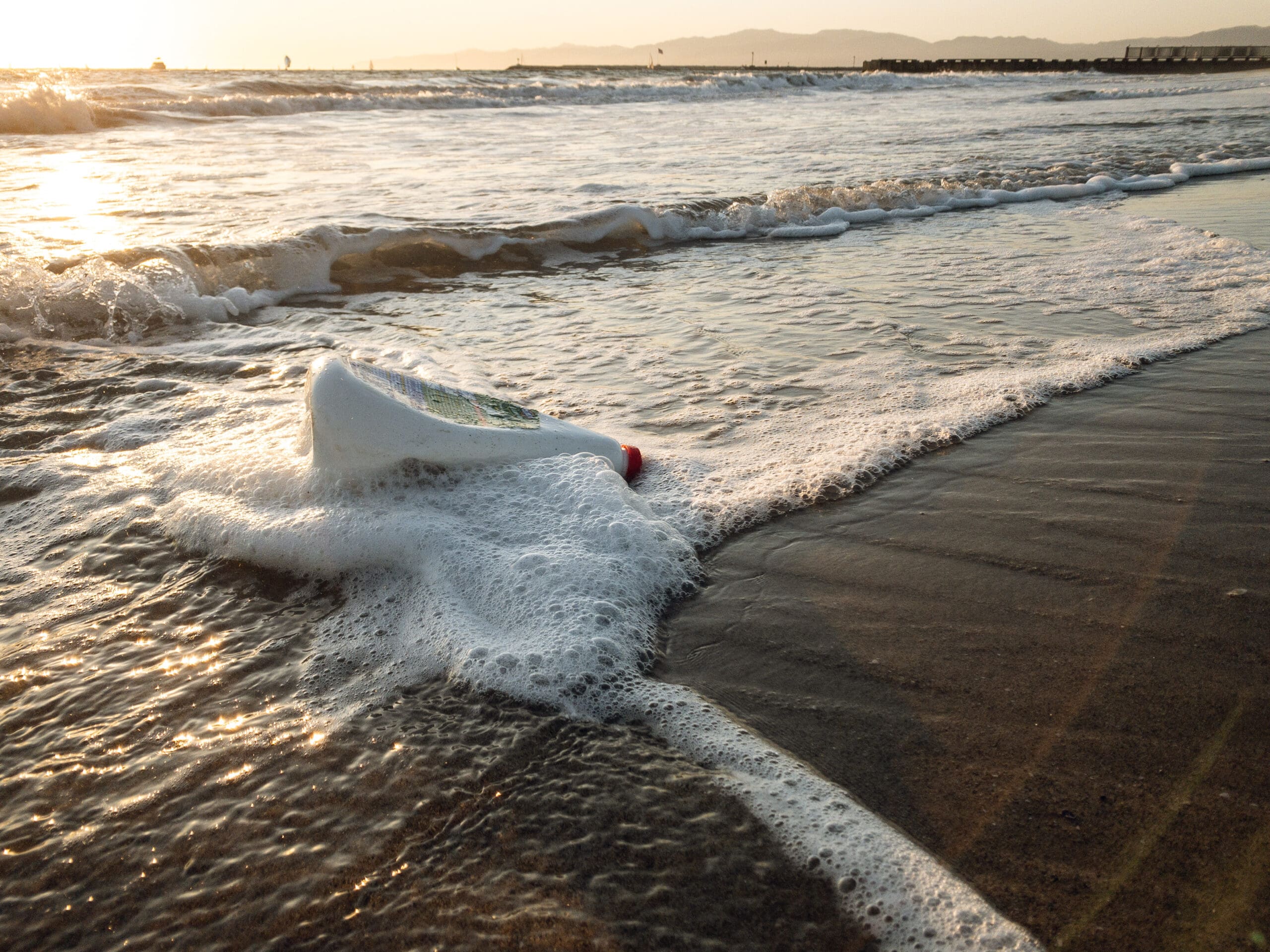 Plastic jug washed up on ocean shore
