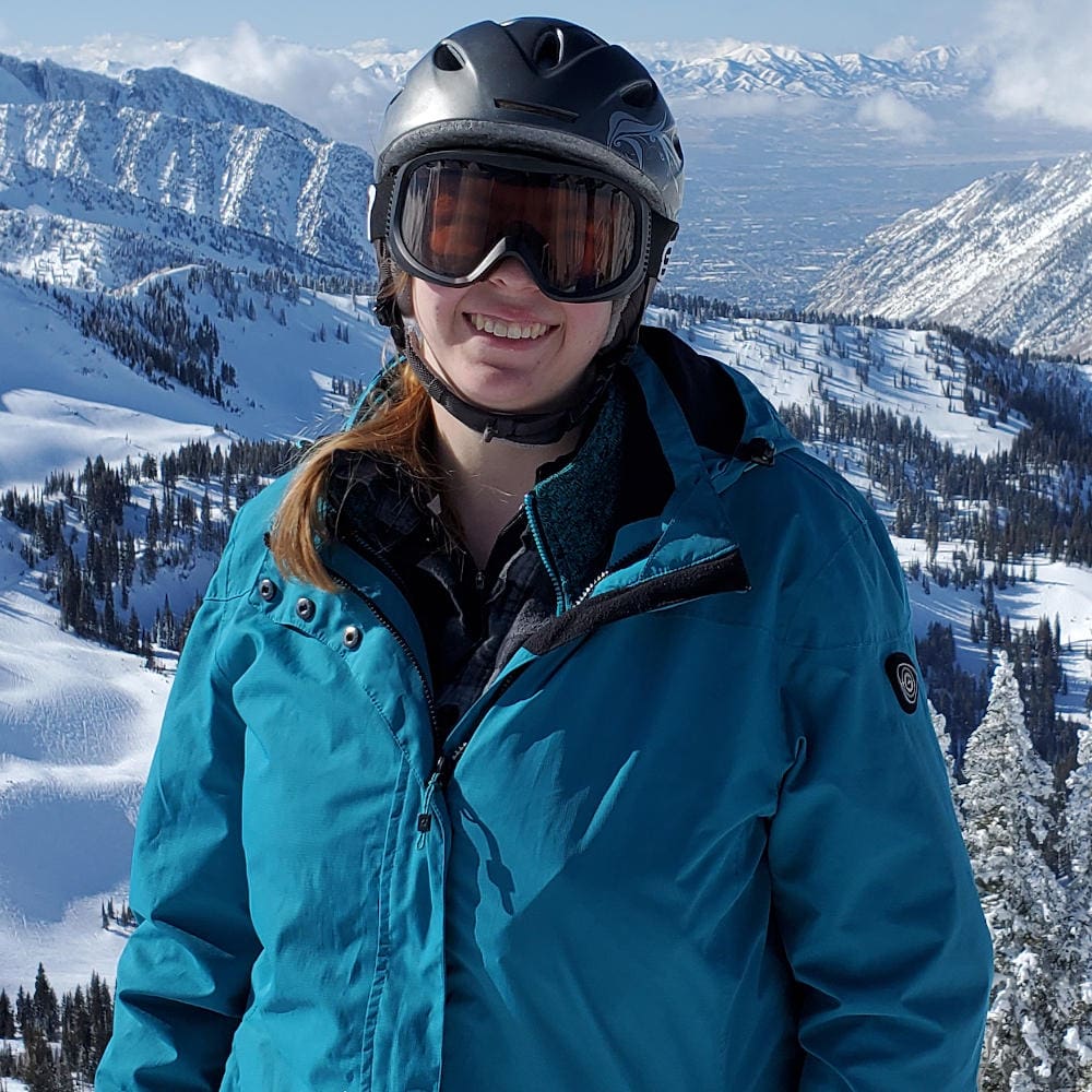 Laura Strong in snow gear in front of mountains