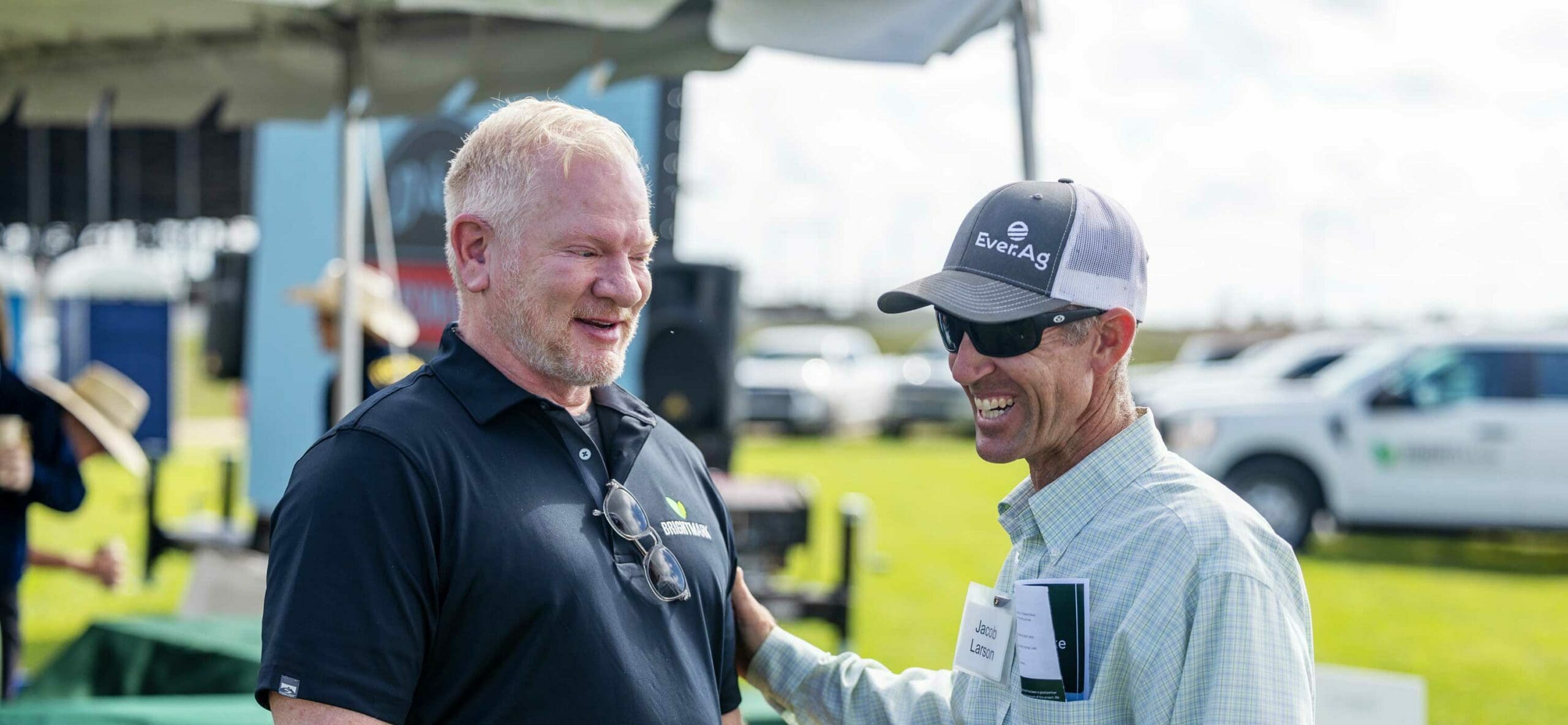 Two men laughing in field