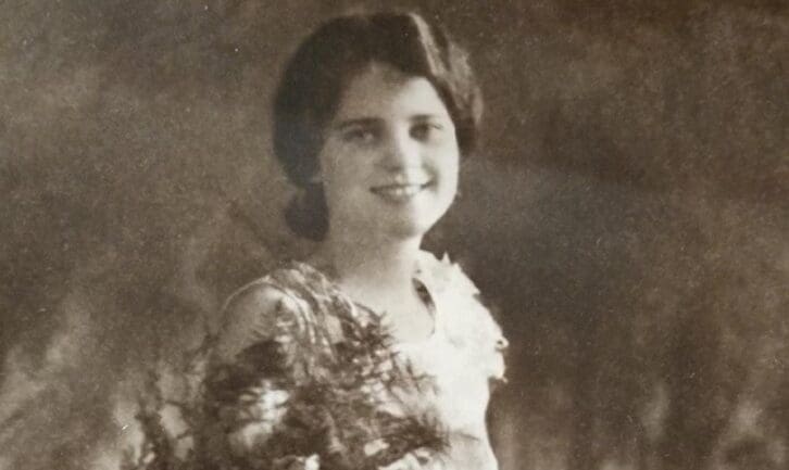 Woman posing holding flowers in black and white photo