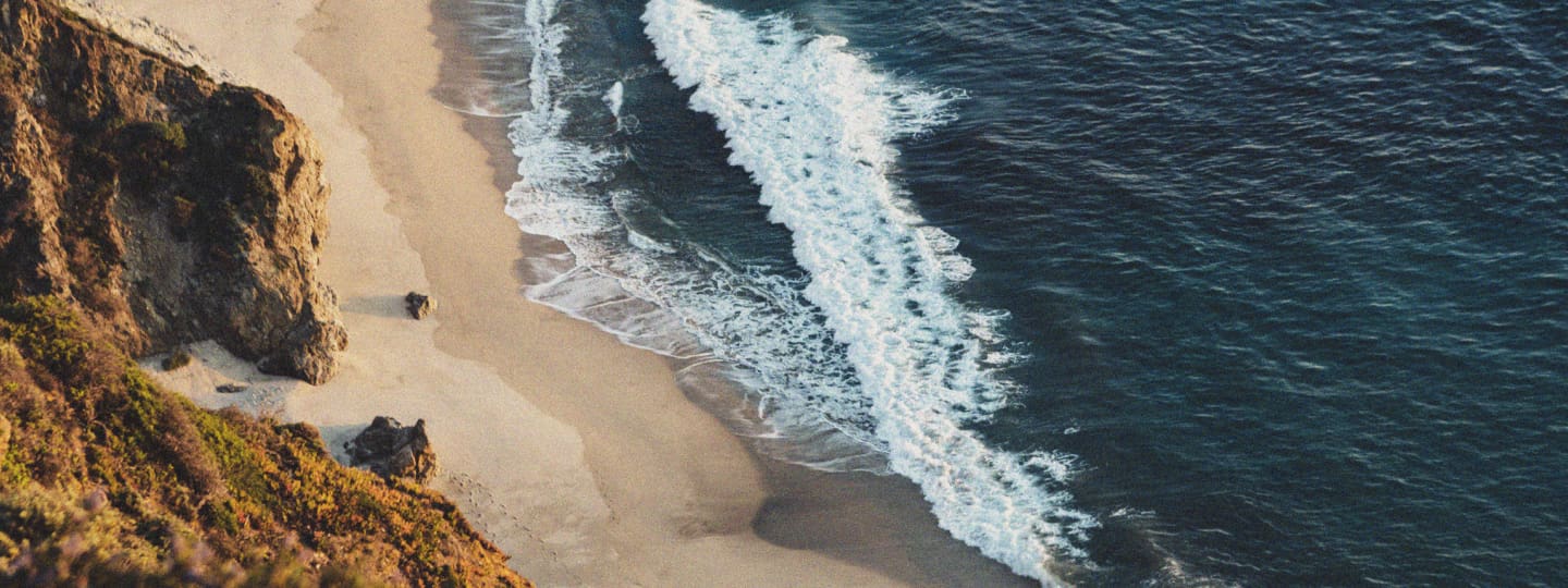 Arial view of ocean waves breaking.