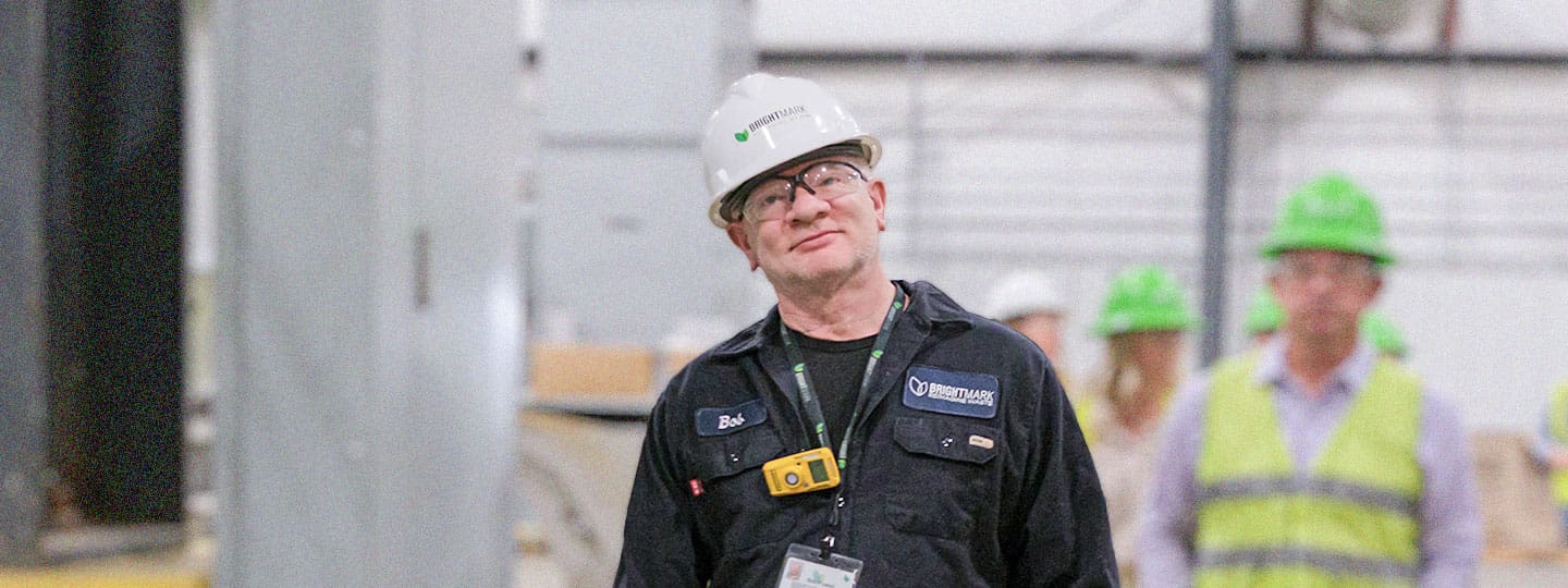 Smiling Bob with Hard Hat in Facility