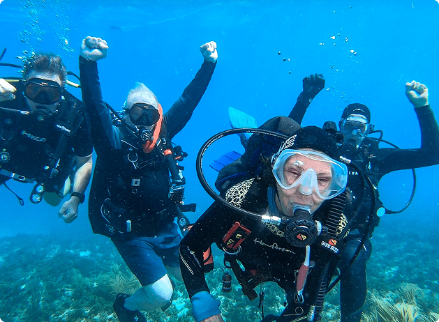 Group of divers underwater posing for the camera